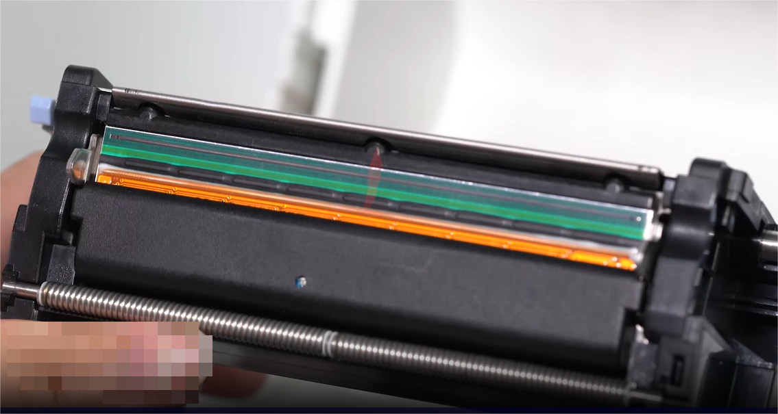 א close-up of a person carefully cleaning an electronic component with a swab.